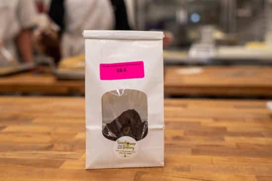 Window bag labeled "Specialty Cookie Dough (NF) - Half-Dozen 16-S" with specialty cookie dough hamantaschen visible through the window.