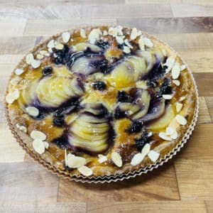 Pear Blueberry Almond Tart on a wood counter