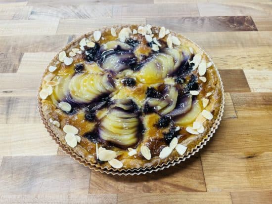 Pear Blueberry Almond Tart on a wood counter