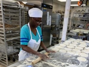 Student at a workplace rolling tortillas