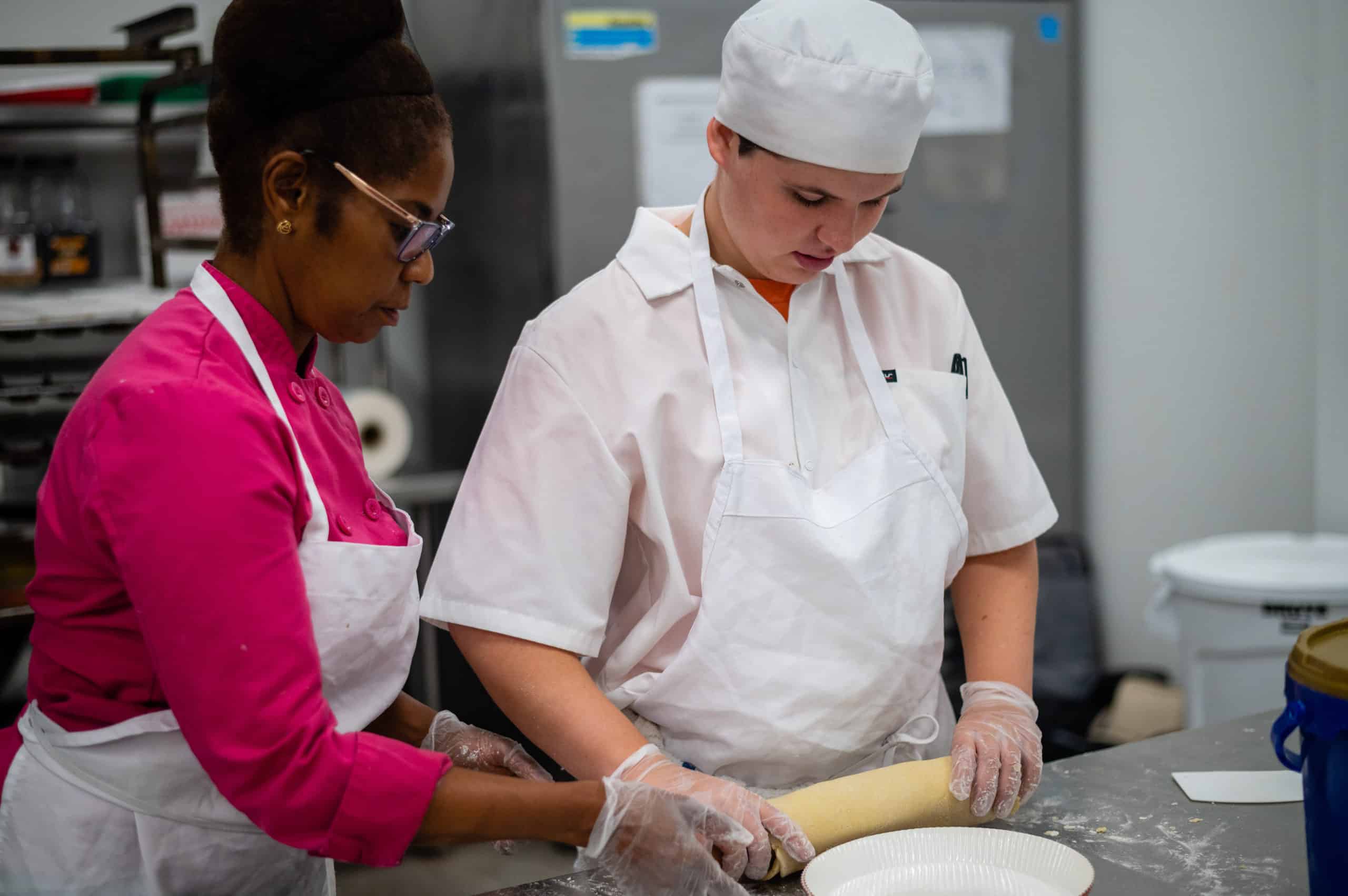 Chef and student rolling tart shells