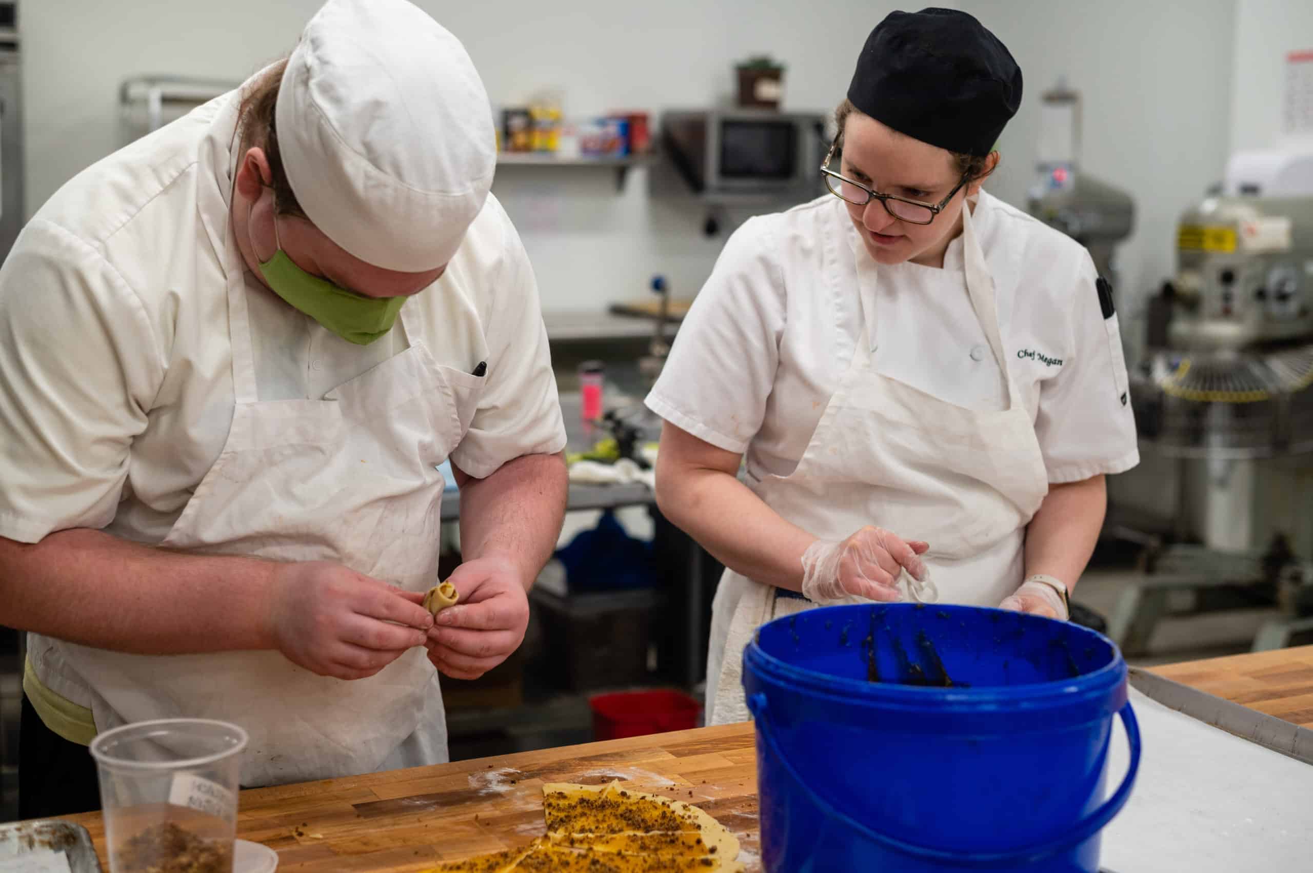 Student rolling rugelach with chef observing