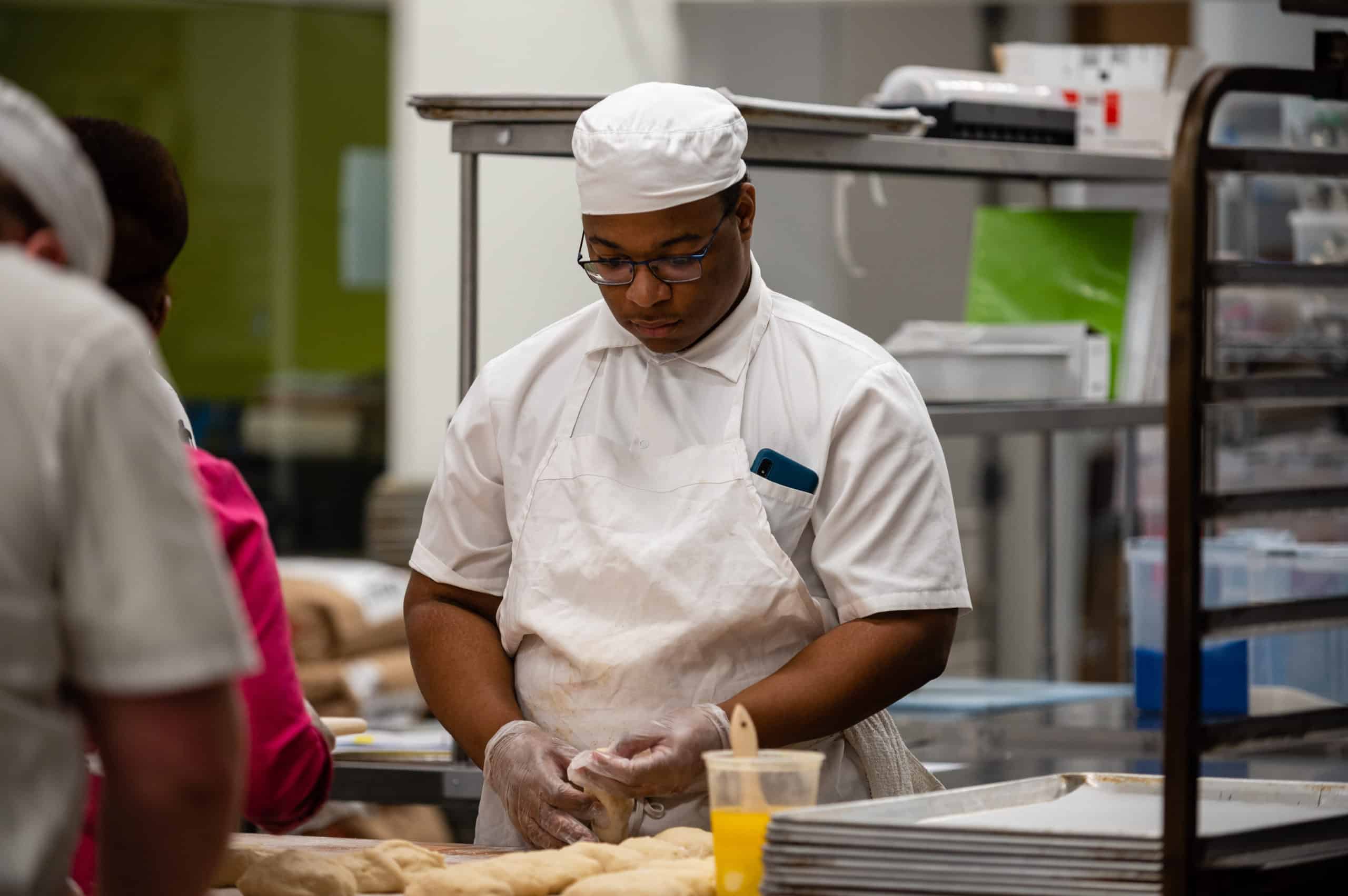 Student working on challah