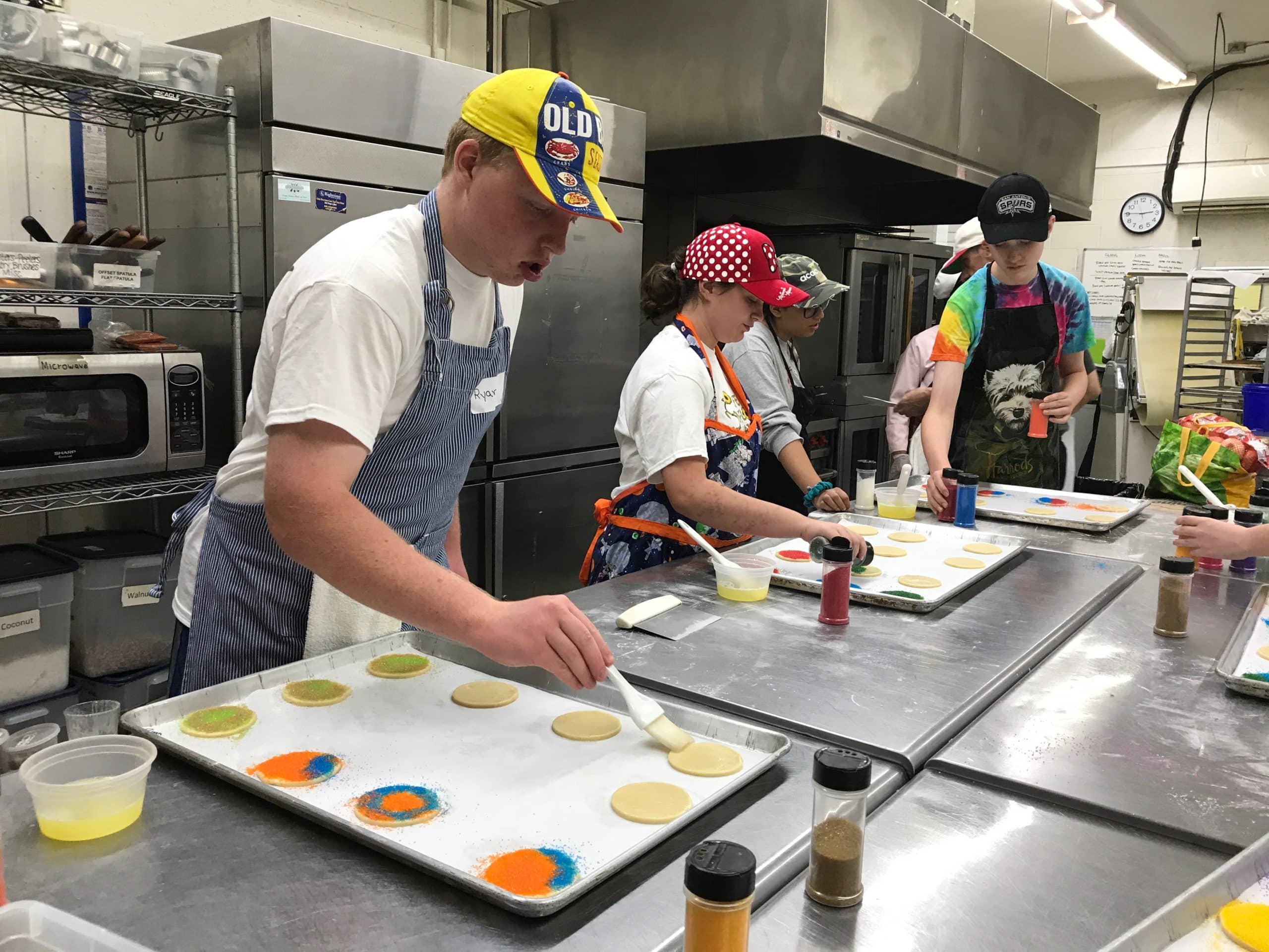 Teen students decorating cookies