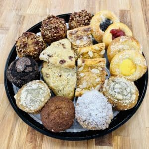 Large breakfast Pastries platter, with 18 pastries. 3 pecan sticky buns, 4 assorted kolache, 5 assorted large muffins, 3 scones, and 3 almond feuillté.