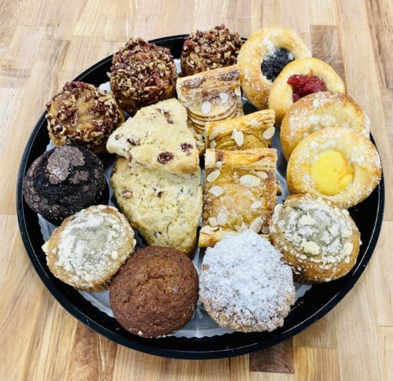 Large breakfast Pastries platter, with 18 pastries. 3 pecan sticky buns, 4 assorted kolache, 5 assorted large muffins, 3 scones, and 3 almond feuillté.