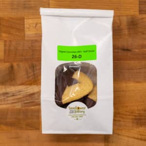 Window bag labeled "Dipped Chocolate (NF) - Half-Dozen 26-D" and traditional chocolate hamantaschen dipped in chocolate visible through the window