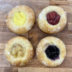 Four flavors of kolache. From the top right, clockwise, lemon, cherry, blueberry, and apple.