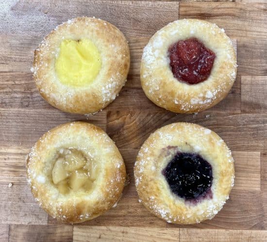 Four flavors of kolache. From the top right, clockwise, lemon, cherry, blueberry, and apple.