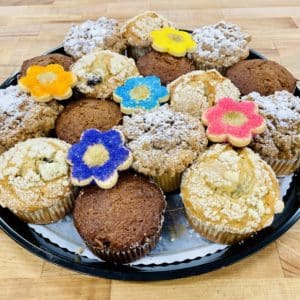 Large muffin platter with 15 muffins, decorated with 5 sunflower sugar cookies. 5 each of morning glory, lemon blueberry, and cinnamon crumb muffins.