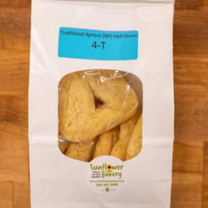 Window bag labeled "Traditional Apricot (NF) - Half-Dozen 4-T" with traditional apricot hamantaschen visible through the window.