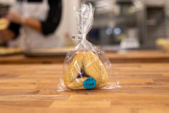 Traditional favor bag, labeled with "39-F Trad". Two traditional hamantaschen can be seen in the cello bag.