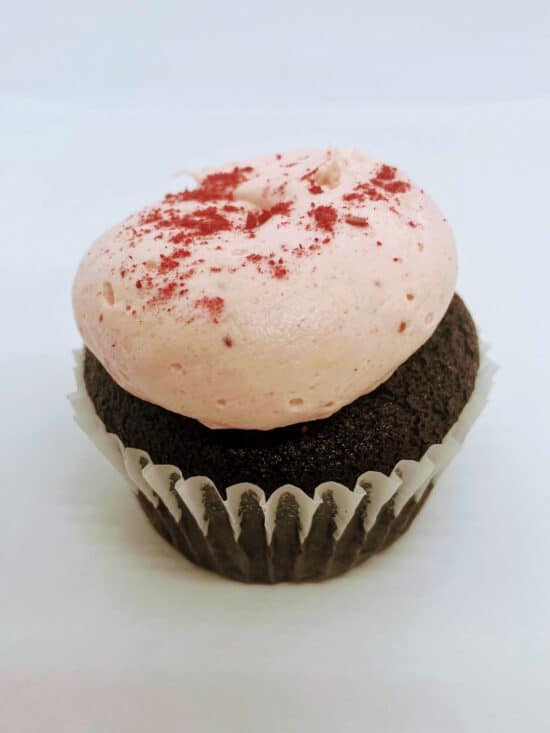 Single Chocolate Strawberry Cupcake, chocolate cake with light pink frosting and freeze dried strawberry powder decoration.