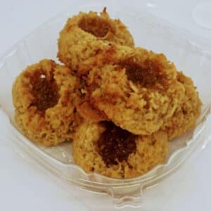 Golden coconut macaroons with a well in the middle, filled with salted caramel.