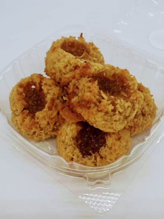 Golden coconut macaroons with a well in the middle, filled with salted caramel.
