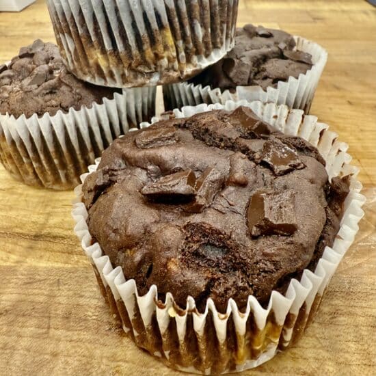 Chocolate Banana & Date Muffins on a wood countertop