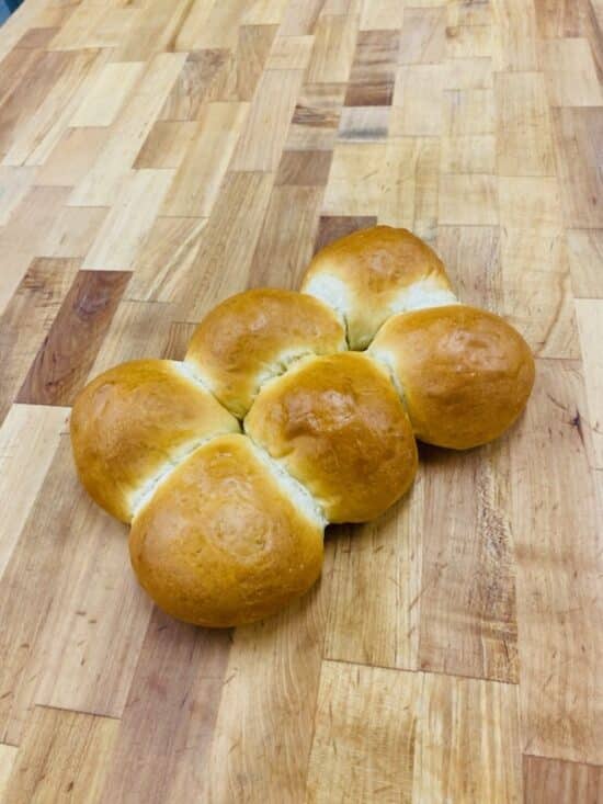 6 Pull-apart challah rolls on a wooden countertop