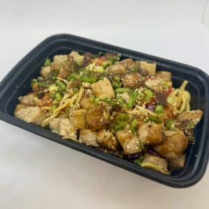 Spicy tofu stir-fry in a to-go container.