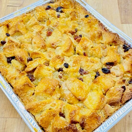 French toast casserole in an aluminum pan on a wooden countertop