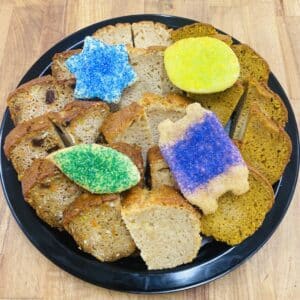 Platter with slices of various tea breads, decorated with Sukkot themed sugar cookies.