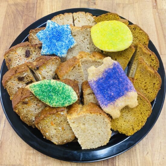 Platter with slices of various tea breads, decorated with Sukkot themed sugar cookies.