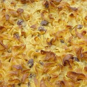 Close up detail of sweet noodle and raisin kugel