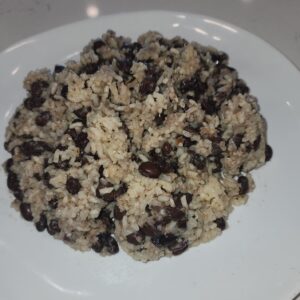 White plate with beans and rice mixed together.