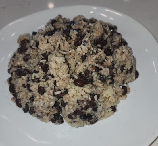White plate with beans and rice mixed together.
